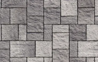 Pavimentazione in cemento con blocchi di colore grigio scuro.