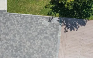 Pavimentazione in cemento con blocchi rettangolari di colore grigio scuro.