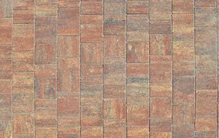 Pavimentazione in blocchi rettangolari dai toni caldi, con sfumature di marrone e arancio.