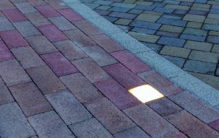 Pavimentazione in pietra con un elemento LED incassato.