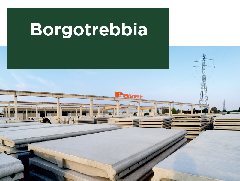 Stabilimento Paver a Borgotrebbia con lastre di cemento in primo piano, un traliccio elettrico e una struttura industriale sullo sfondo. Testo 'Borgotrebbia' su sfondo verde.